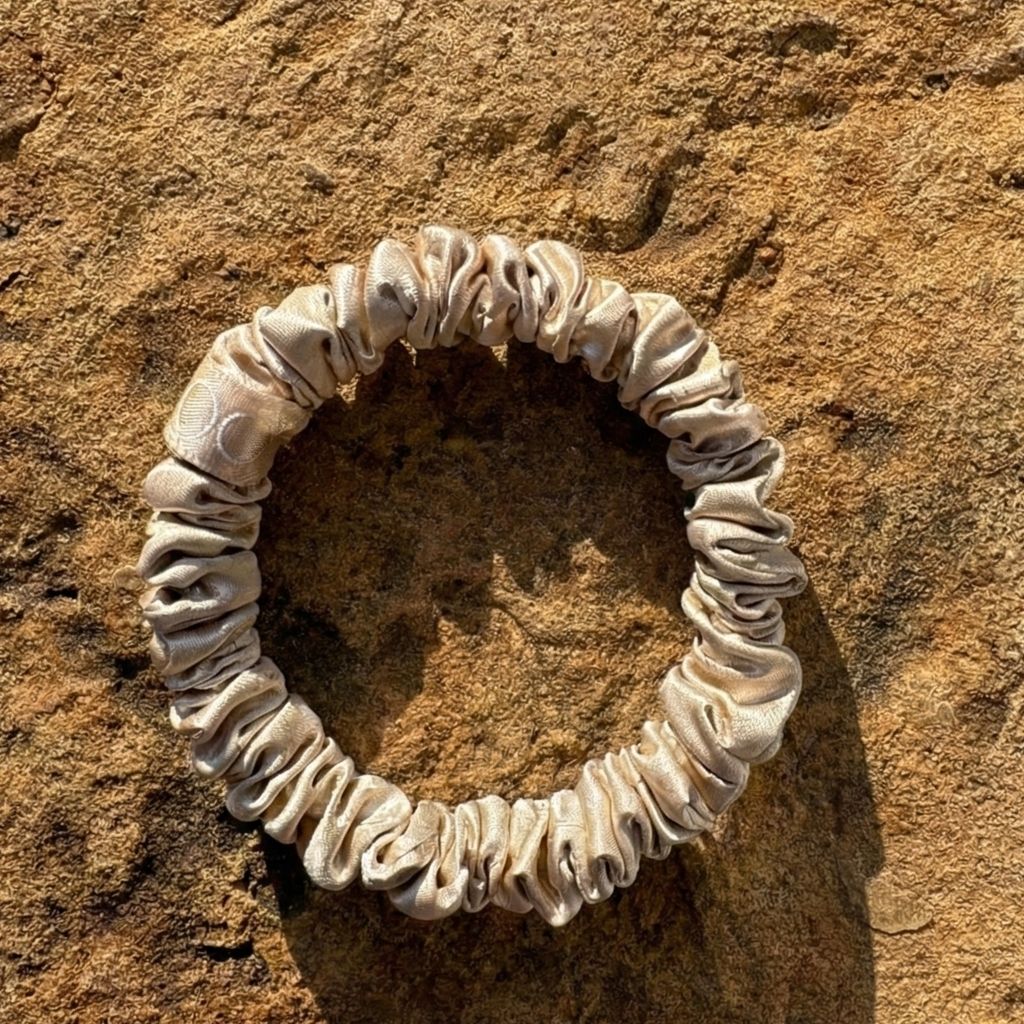 Coletero de seda natural dorado de Onisa Coté sobre piedra natural, accesorio anti-rotura para el cabello.