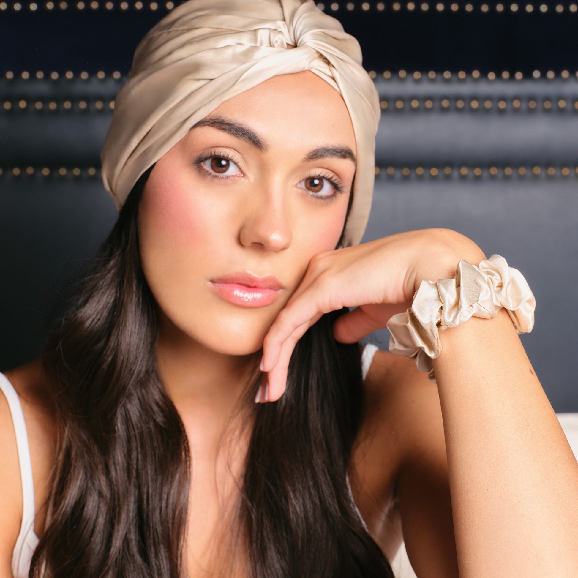 Retrato de modelo con turbante de seda champagne Onisa Coté y coletero a juego